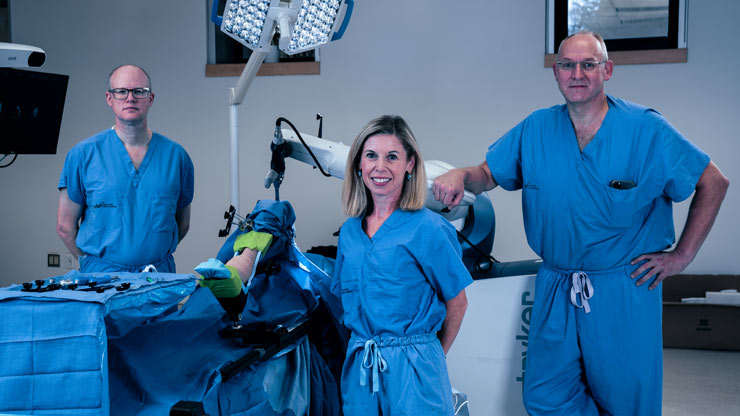 Dr. Glen Richardson, Dr. Janie Wilson and Dr. Michael Dunbar with the orthopaedic robot.