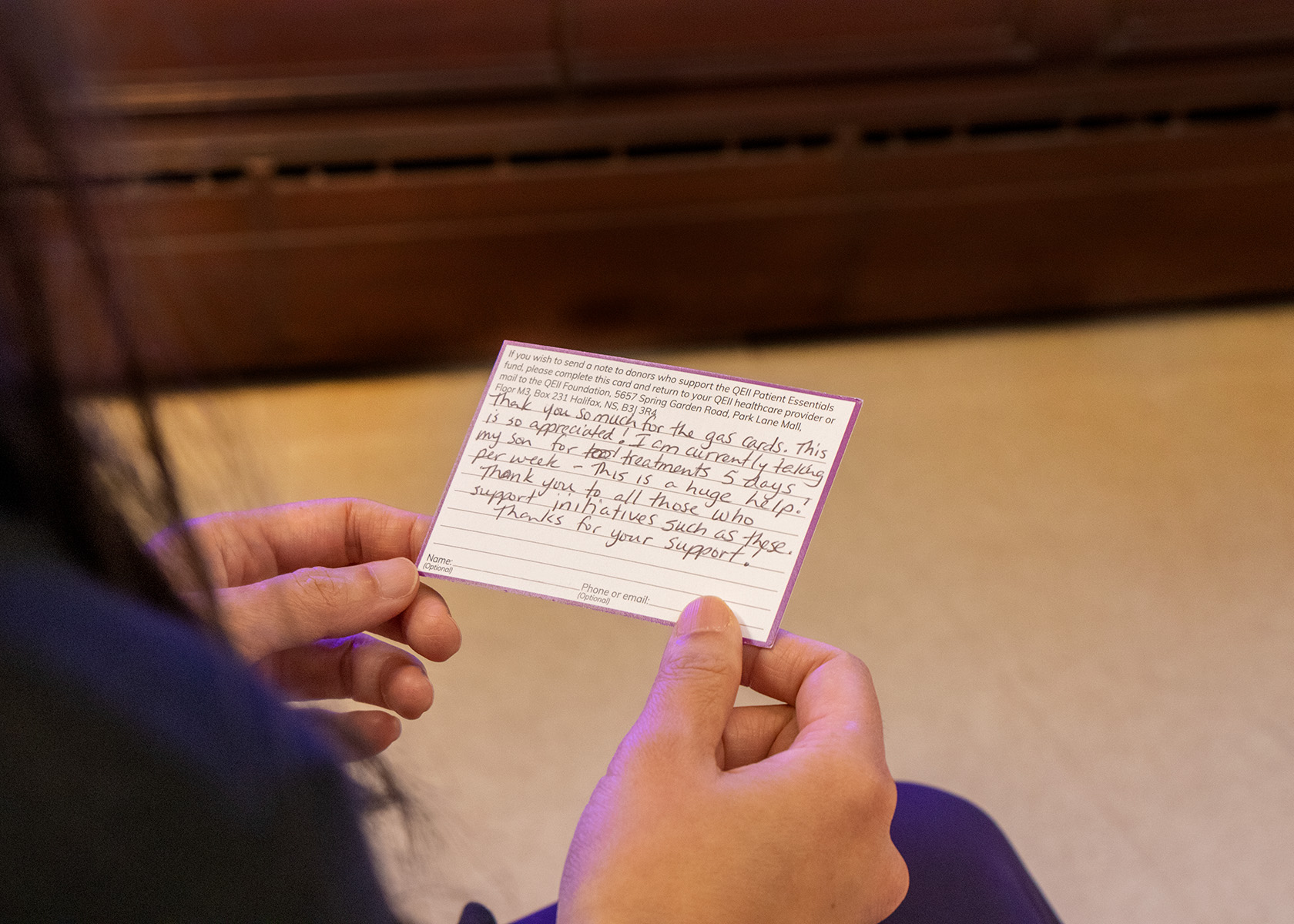 A person, not pictured, reads a thank-you note from a grateful patient. 