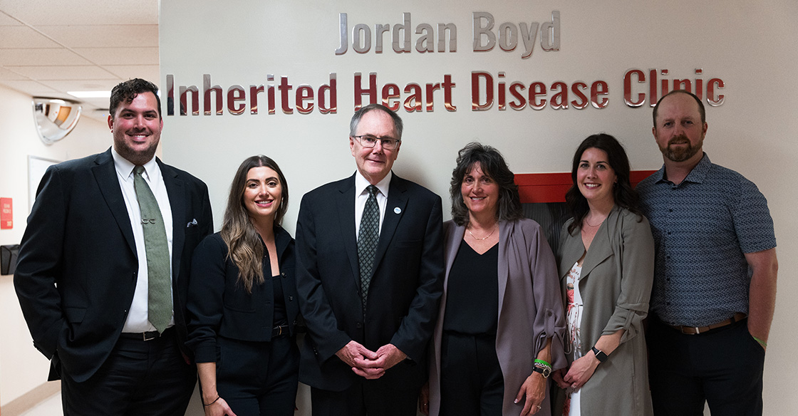 Boyd family stands in front of sign