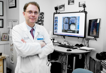 Dr. David Clarke, head of the division of neurosurgery at the QEII, stands in front of the StealthStation. This new technology enables neurosurgeons to carry out surgery more effectively, efficiently and in a way which is ultimately safer for the patient. 