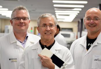 Dr. David Conrad, Dr. Alan Fine and Dr. Rob Liwski show off the hand-held prototype.