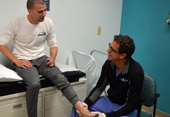 Plastic surgery patient Gregg McCulloch has his foot examined by Dr. Jason Williams.