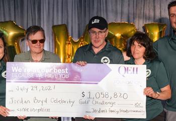 Members of the Boyd family smile with a giant cheque presented to the QEII Foundation and QEII's Inherited Heart Disease Clinic