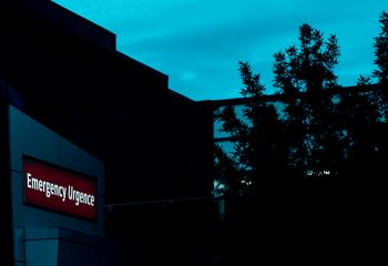 A close up outdoor night time photo of the emergency sign on the Halifax Infirmary building