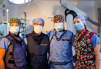 Staff pictured in the QEII's new Stewart E. Allen Hybrid OR, wearing scrubs and masks