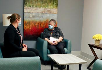 A renovated family room with two women having a conversation