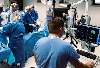 A group of QEII surgeons gather around the Mako SmartRobotic system