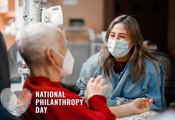 A male patient and female nurse having an animated, friendly conversation during his chemotherapy treatment. 