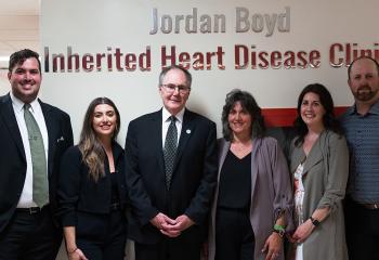 Family standing in front of clinic sign