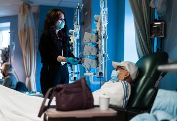 A QEII patient enjoys a warm blanket during cancer treatment. 