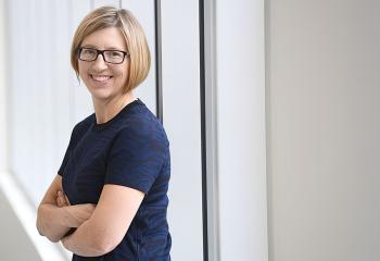 Dr. Robin Urquhart stands with her arms crossed