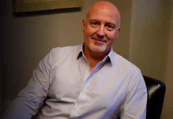 Dr. Phil Tibbo sitting in office chair.