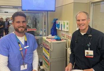 A QEII emergency department pharmacist and emergency medicine physician pose for the camera in the QEII's emergency department.