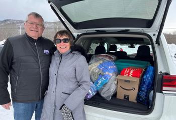 A patient's parents stand by the car full of blanket donations for the QEII.