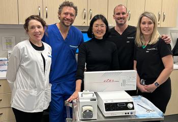 A healthcare team poses with the new thyroid procedure equipment.