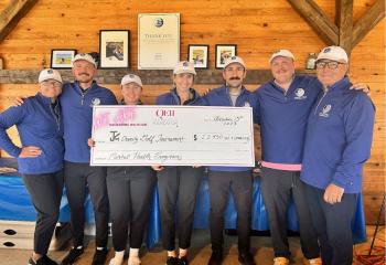 Joe Keevill’s family and friends holding cheque donation to QEII Foundation