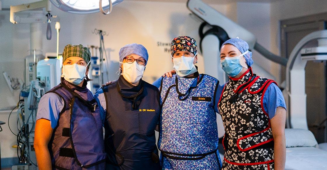 Staff pictured in the QEII's new Stewart E. Allen Hybrid OR, wearing scrubs and masks