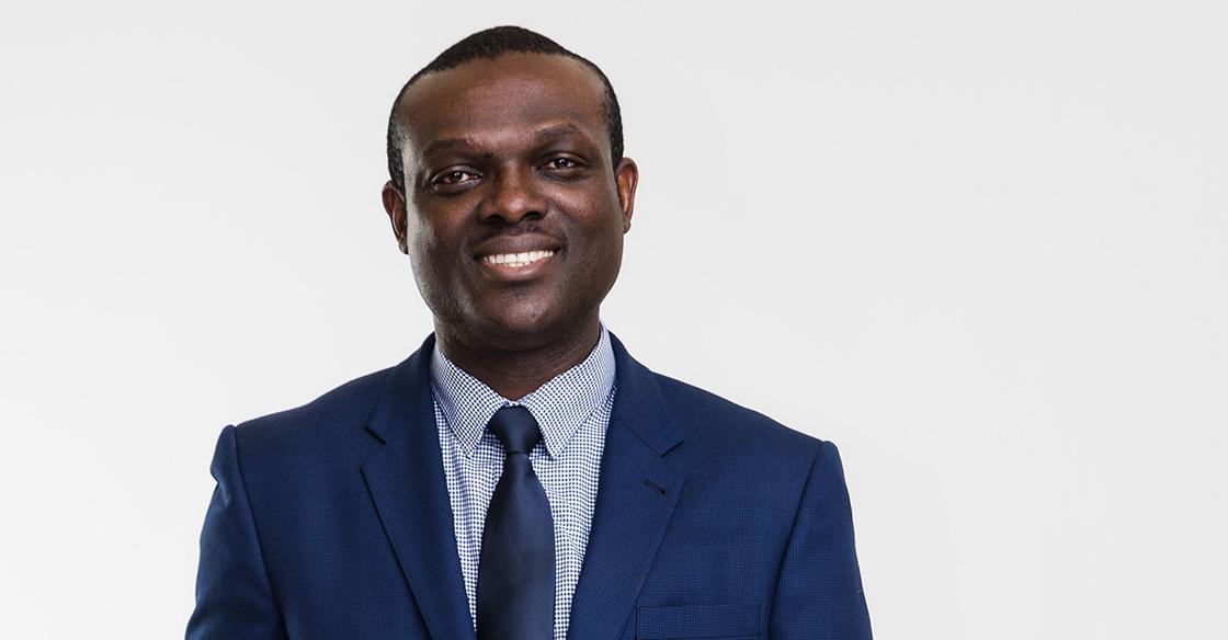 Dr. Vincent Agyapong portrait headshot in a dark blue navy suit against a white background