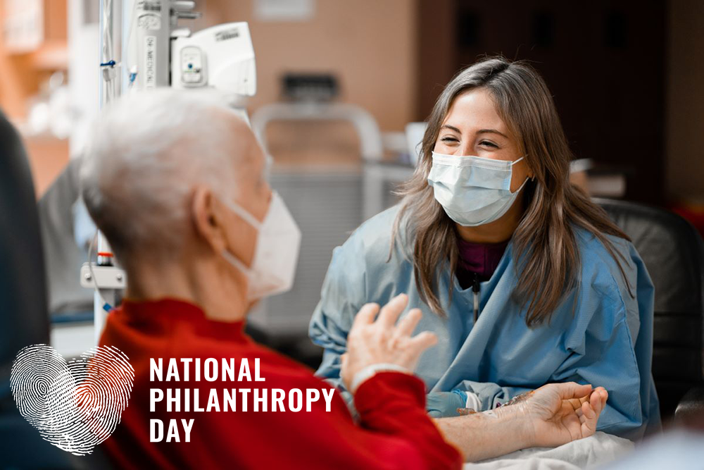A male patient and female nurse having an animated, friendly conversation during his chemotherapy treatment.