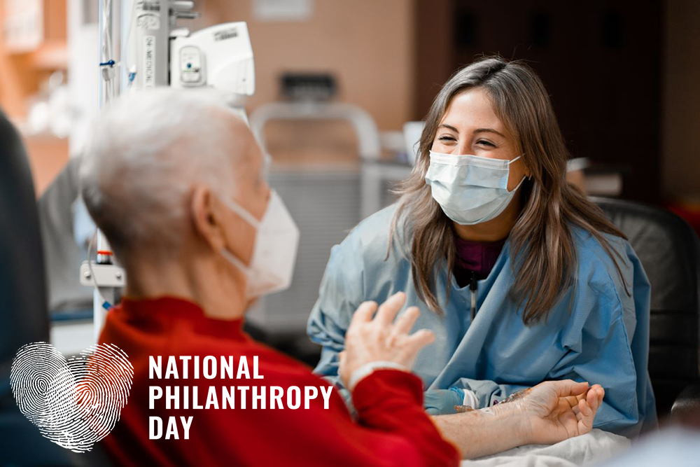 A male patient and female nurse having an animated, friendly conversation during his chemotherapy treatment. 