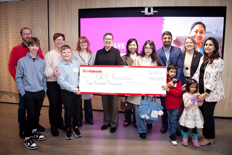 A group of people celebrate Scotiabank's donation to the NICHE program with a large cheque.