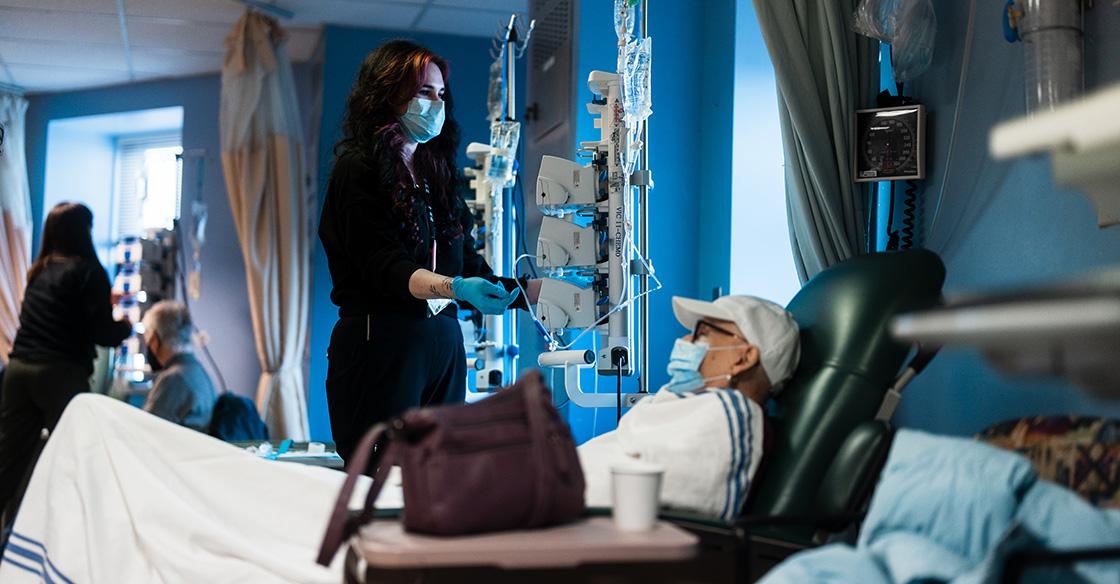 A QEII patient enjoys a warm blanket during cancer treatment.