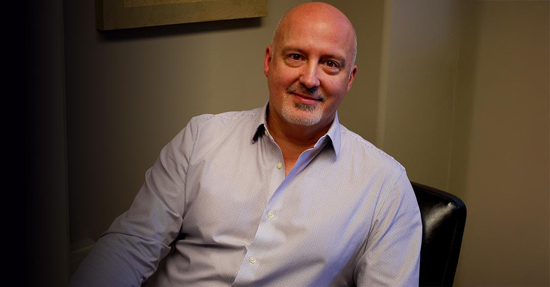 Dr. Phil Tibbo sitting in office chair.