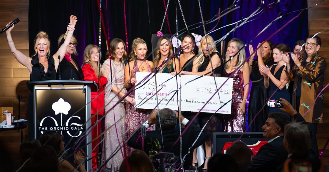 Cheque presentation photo on stage at Orchid Gala event