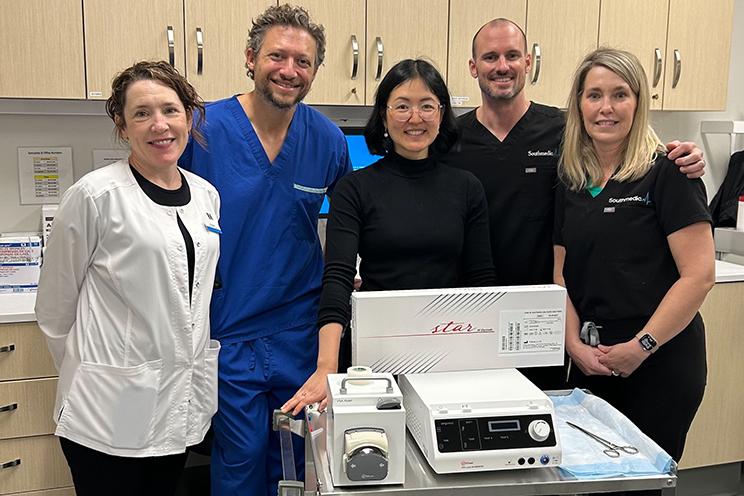 A healthcare team poses with the new thyroid procedure equipment.