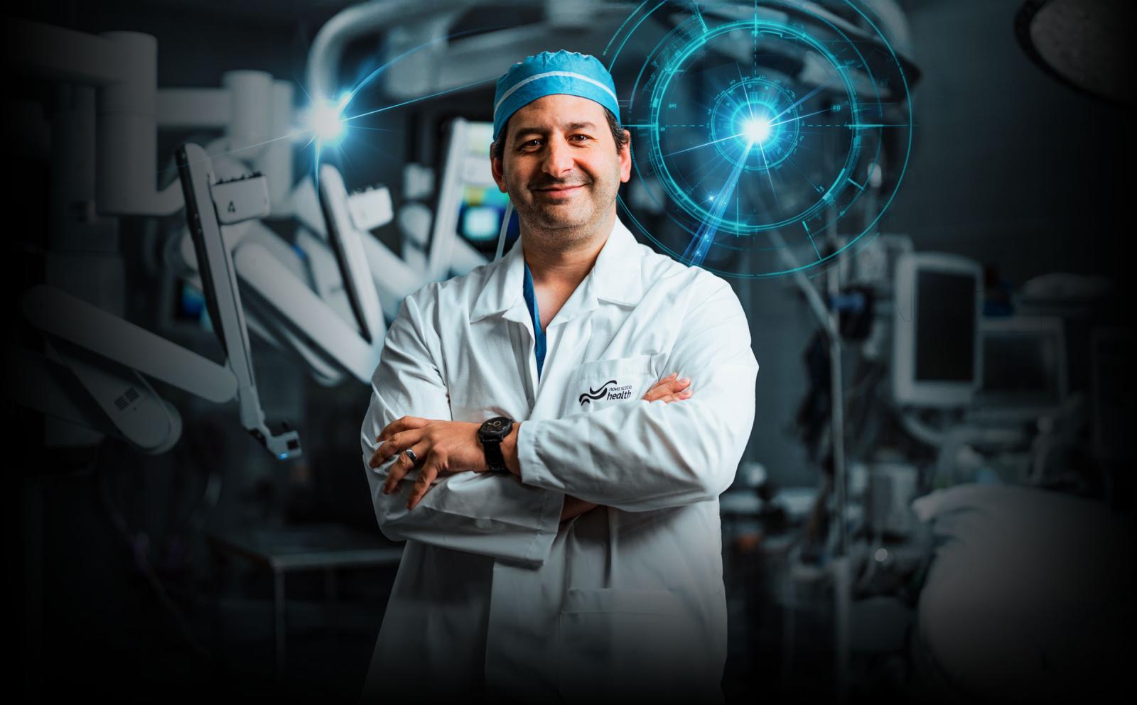 Dr posing in front of the da Vinci Xi Robot