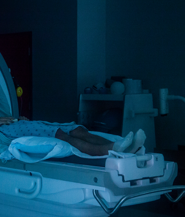 A nurse prepares a patient for an MRI