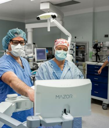 Doctors using spinal robot