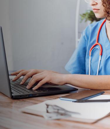 Healthcare professional using laptop
