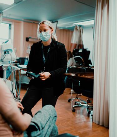 female healthcare worker talking to a male patient