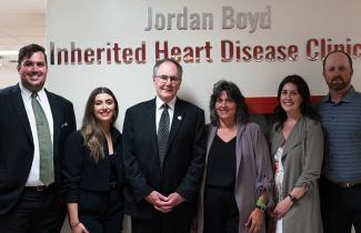 Family standing in front of clinic sign