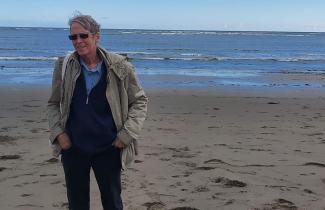 David Ferrigno standing on a beach