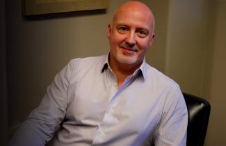 Dr. Phil Tibbo sitting in office chair.