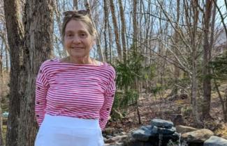 Pictured: Cheryl Bigood practices standing straight after receiving scoliosis surgery with the QEII's donor-funded surgical robot for spinal surgeries. 