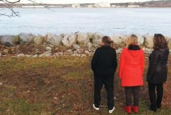 Murphy family standing at the waters edge in Liverpool